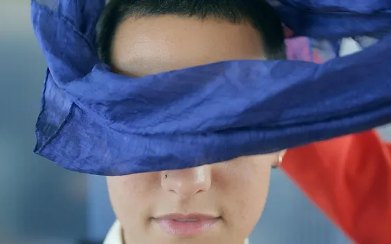 A face with a blindfold being removed. Still image from a documentation film about Movement Alphabet by Jan-Ming Lee and Tim Murray-Browne.