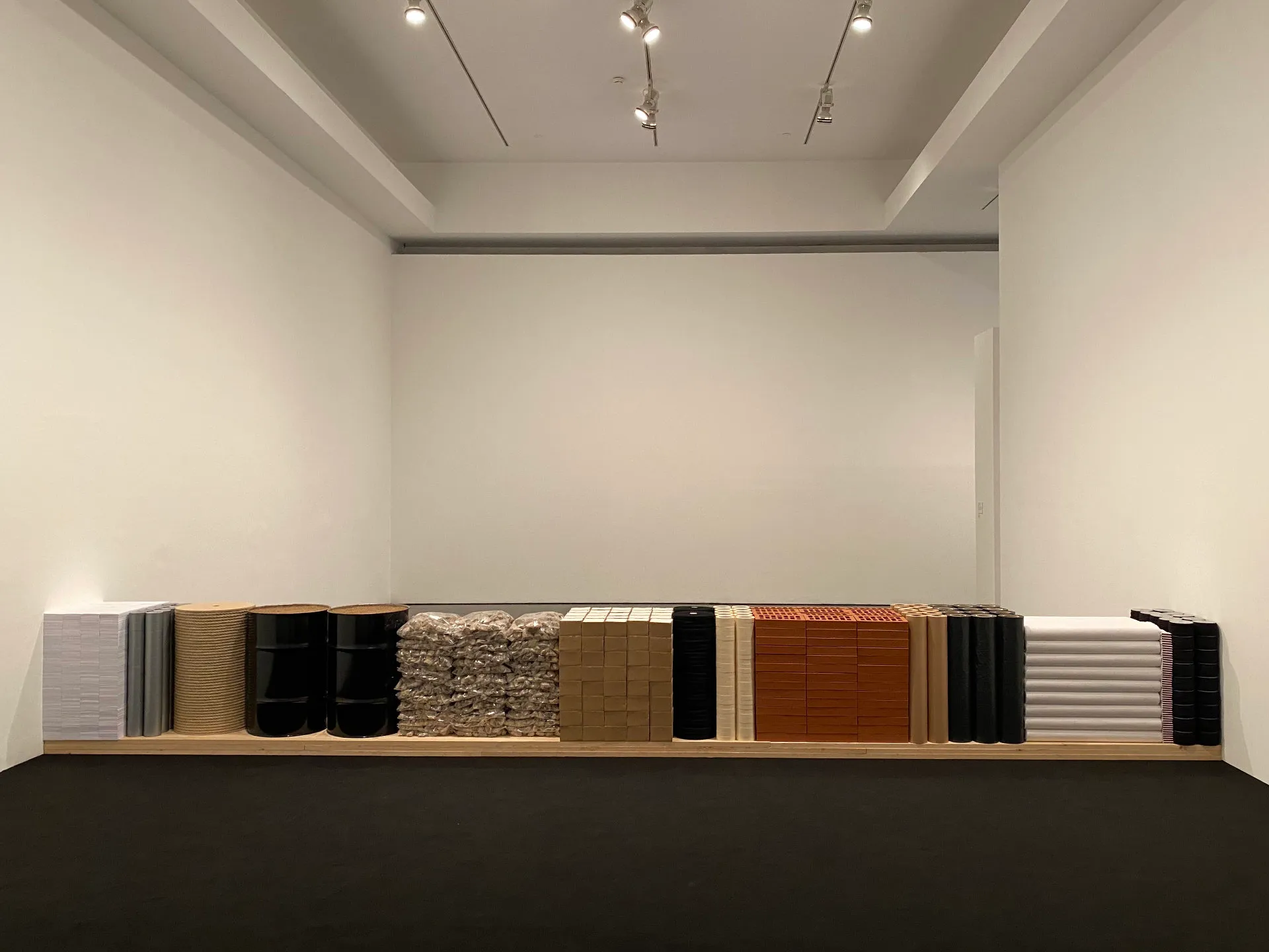 Photo of the second room at Cinthia Marcelle's exhibition 'A Conjunction of Factors'. It shows the same materials as in the first room but neatly arranged prior to use on a single plank of wood. Photo by Tim Murray-Browne.