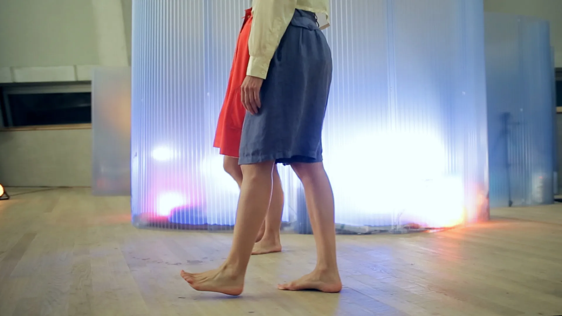 A video still showing the participant and host's bare feet walking on the ground past the pod. Taken from a film created by Mind The Film of Movement Alphabet by Jan-Ming Lee and Tim Murray-Browne