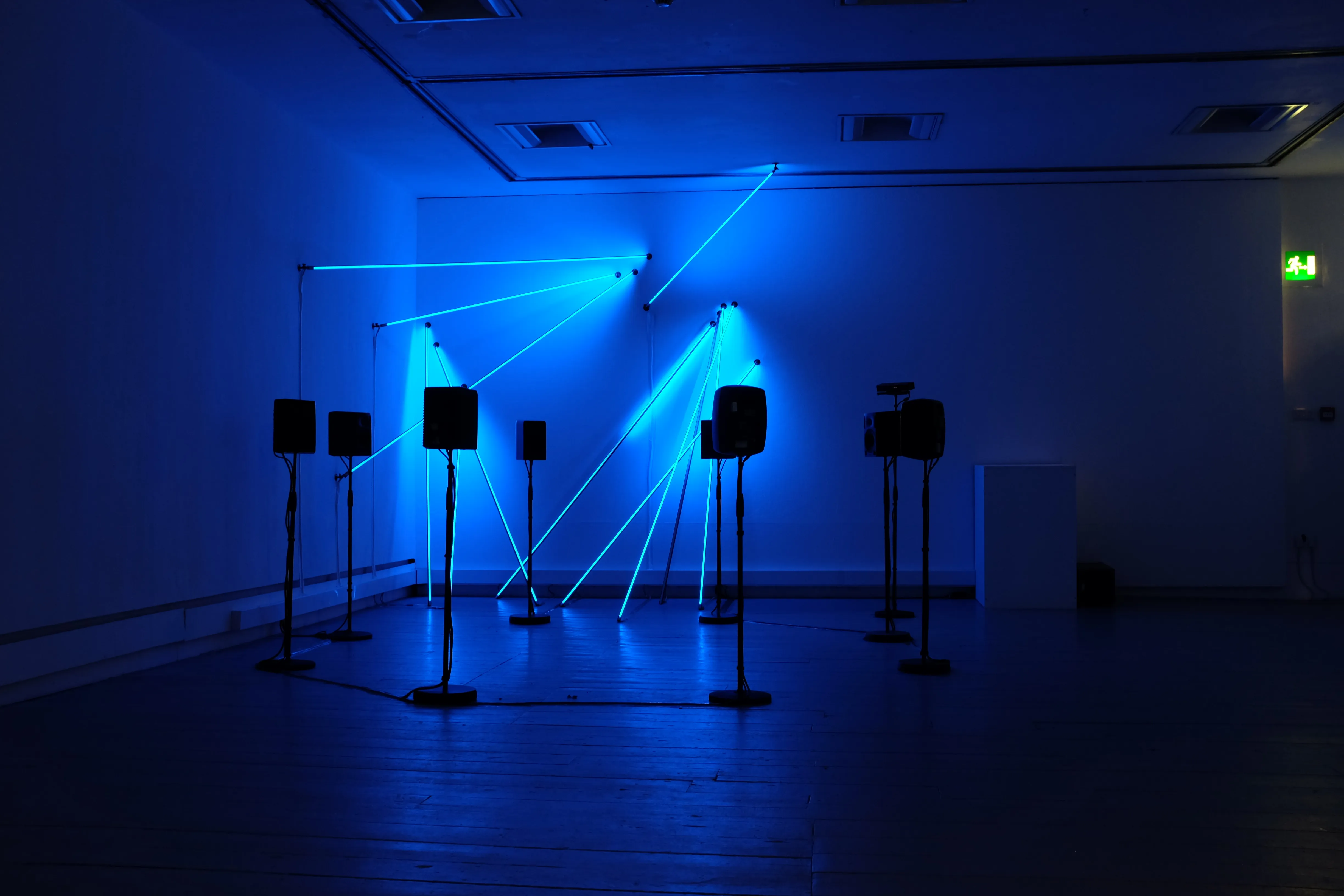Post-Truth and Beauty, an interactive installation by Tim Murray-Browne and Aphra Shemza formed of addressable LED rods rigged to the wall and an ambisonic ring of speakers. This photo shows the work exhibited at Sonica Festival in Glasgow, 2019.