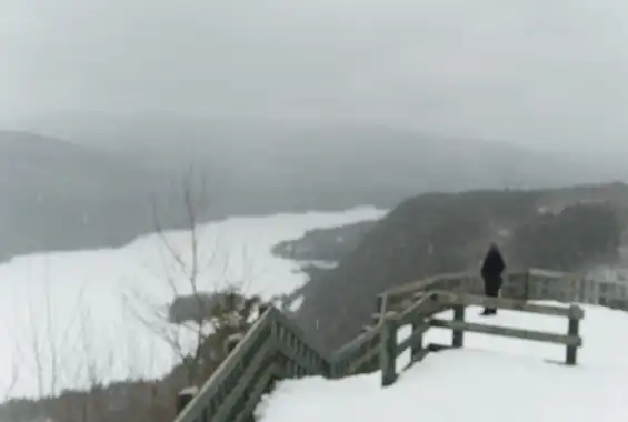 An out-of-focus photograph showing a snowy valley, taken by Tim Murray-Browne